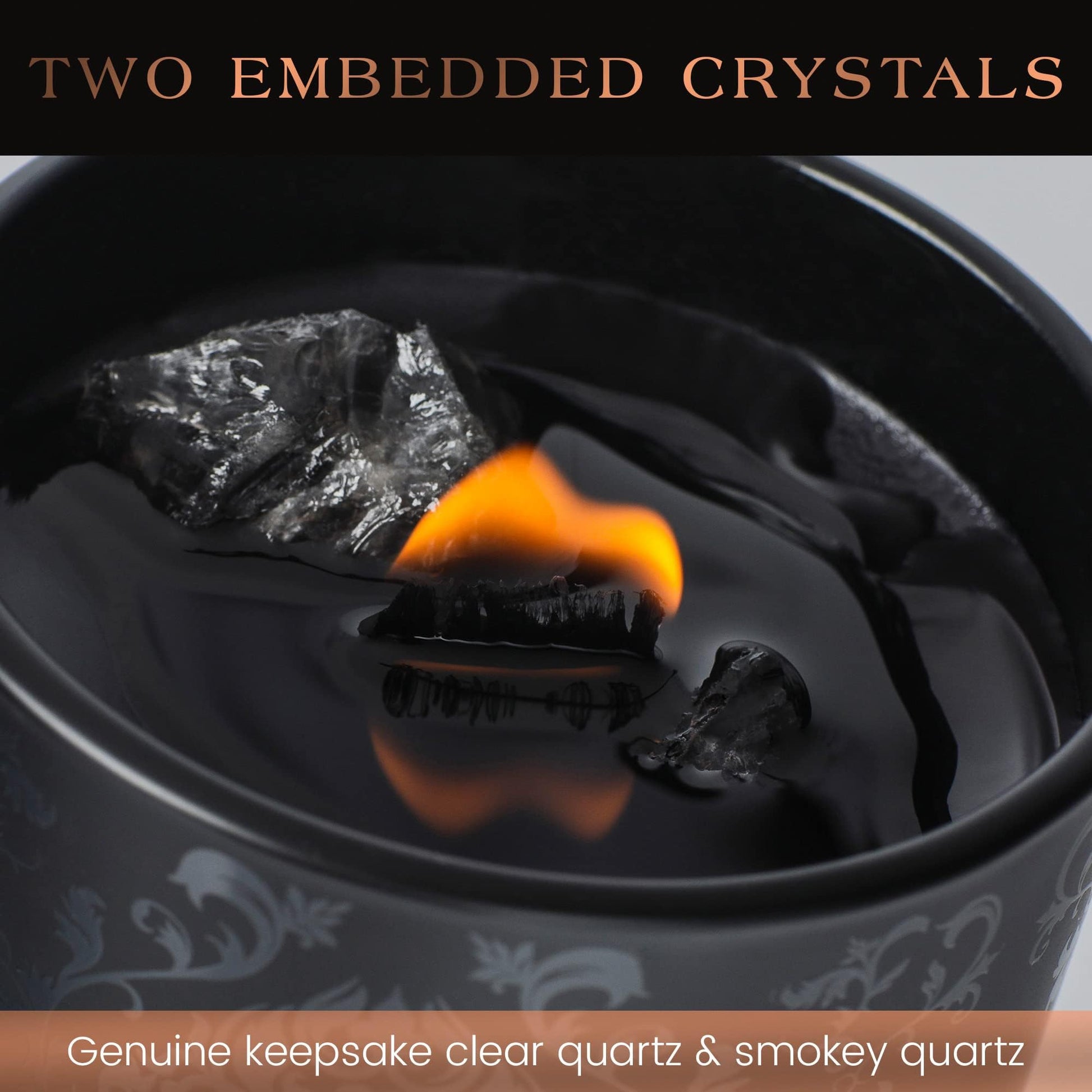 Close-up of a black candle with embedded clear quartz and smoky quartz crystals and a burning flame.