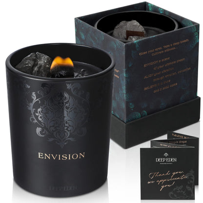 Black Envision candle with decorative crystals shown alongside its matching Deep Eden packaging and thank-you card on a white background.