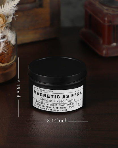 Magnetic As F*ck candle in a black tin shown with dimensions on a dark wooden surface.