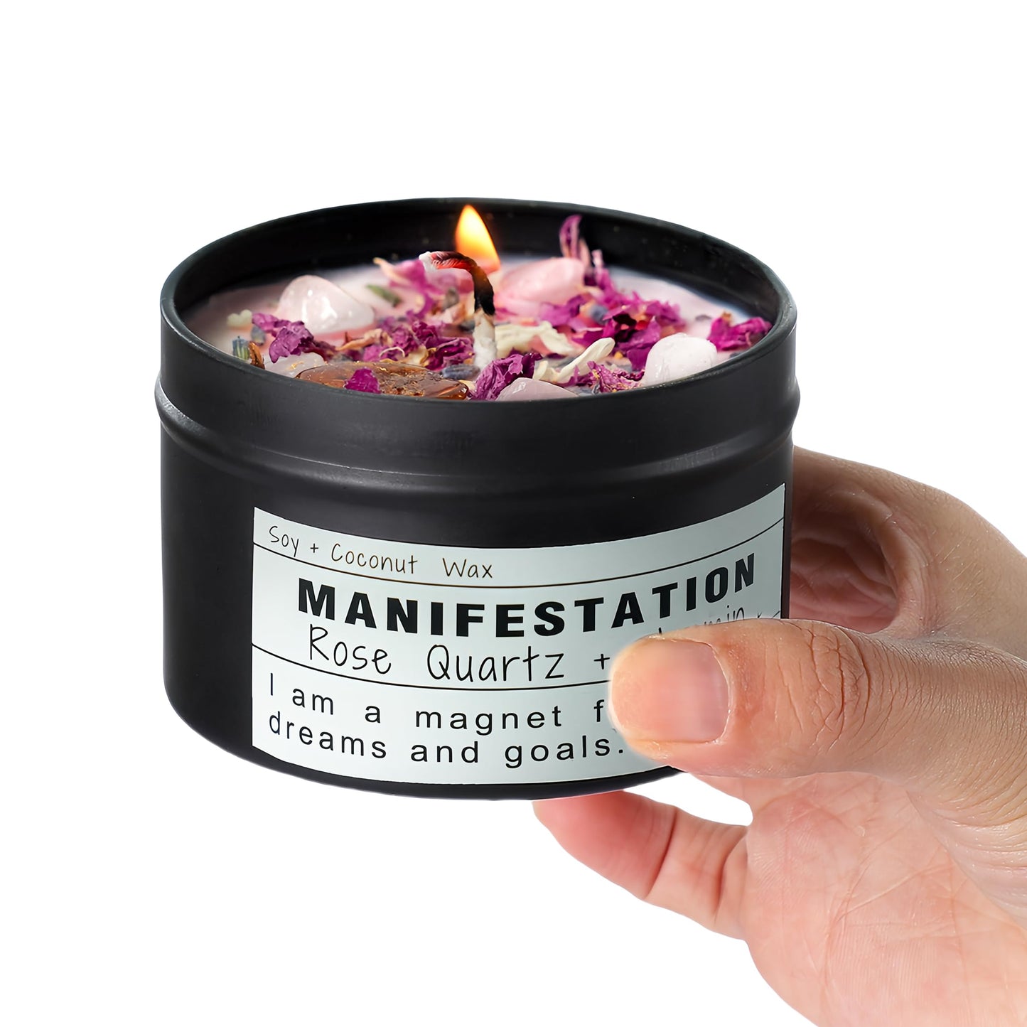 Manifestation candle held in a hand against a white background