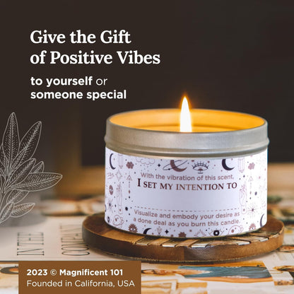 Intention-setting candle burning in a decorative tin on a wooden coaster with text promoting it as a positive vibes gift.